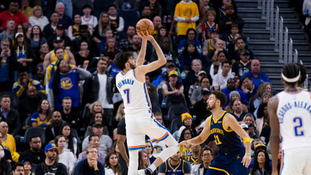 Thunder's Chet Holmgren shoots over Warriors' Klay Thompson. 